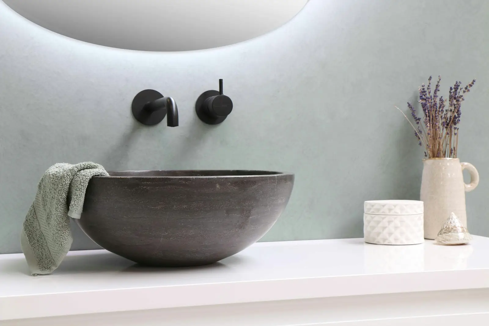Stone basin with black wall-mounted taps